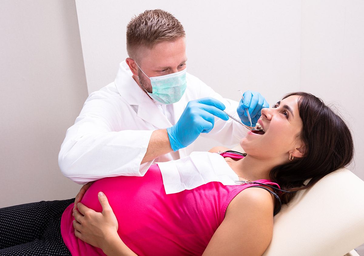 Pregnant woman having dental surgery