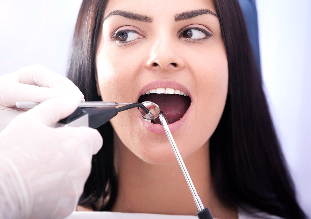 Woman having surgery at dental clinic