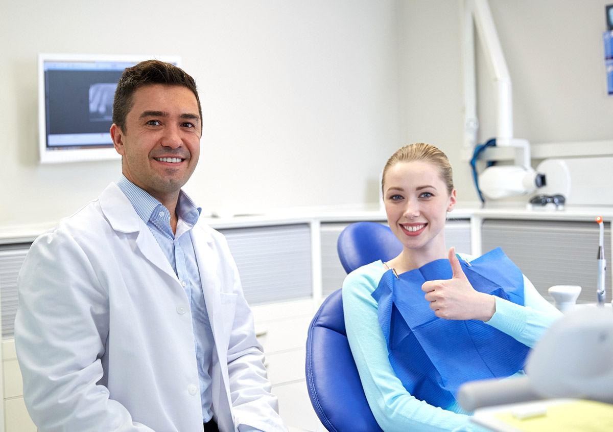 Patient and dentist smiling