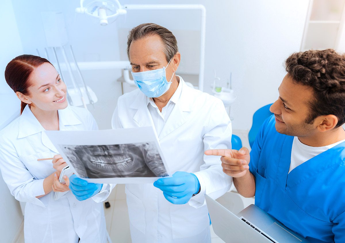 Dentists examining the x ray report